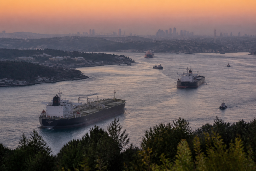 Oil tanker traffic near a major shipping route, illustrating the impact of oil prices on urban transport and supply chains