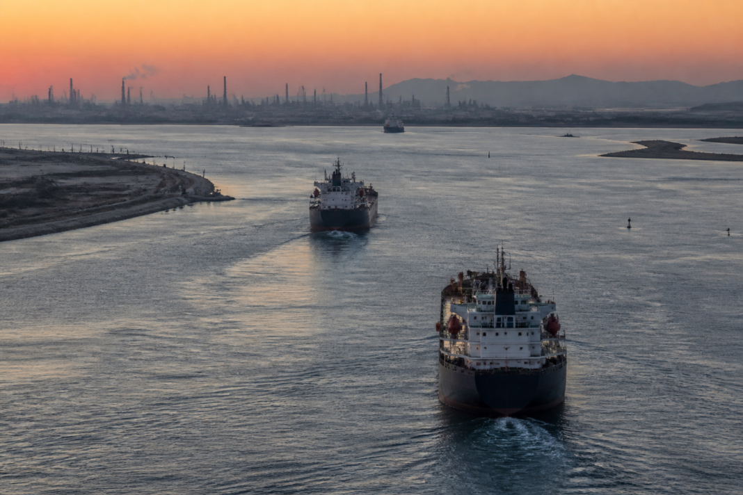 Oil tanker traffic near a strategic maritime passage, illustrating rising oil prices and supply disruption concerns