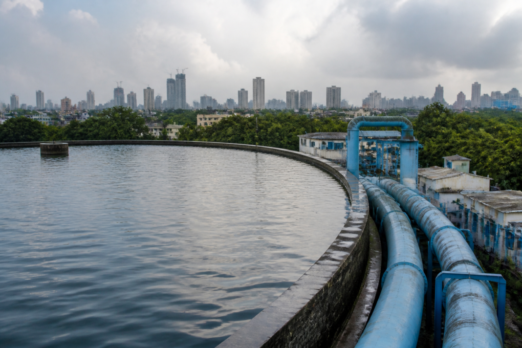 Mumbai water supply infrastructure with reservoir water and municipal pipelines representing the city’s ongoing water management challenge