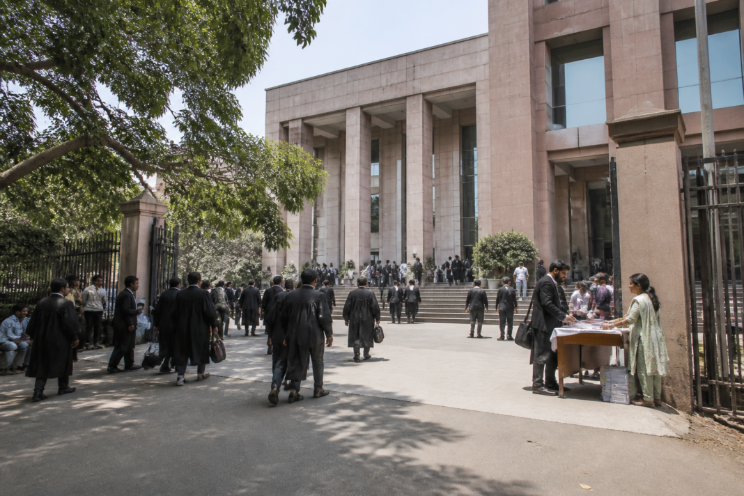 Delhi National Lok Adalat notice and a district court complex representing the October 25 rescheduled hearing