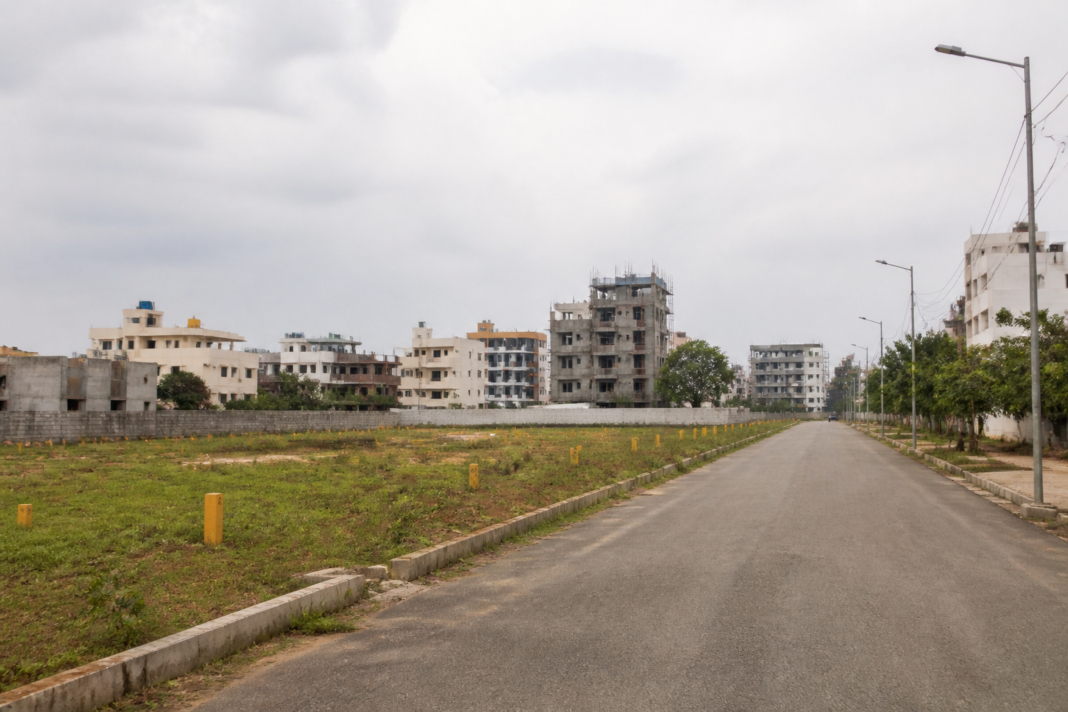 Arkavathi Layout land dispute represented by a Bengaluru residential layout road and undeveloped plots