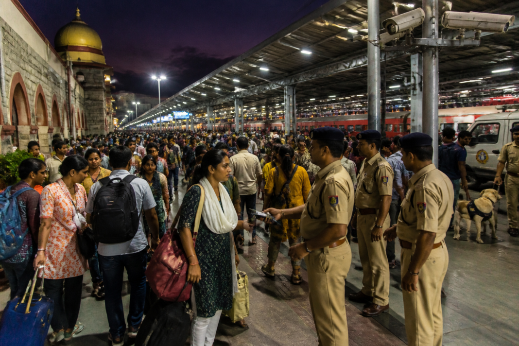 Bengaluru railway security personnel monitoring passengers at a crowded railway station