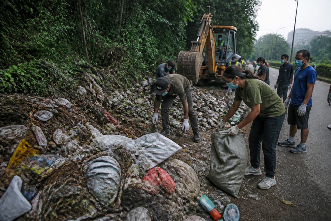Turahalli forest waste being cleared by volunteers and a backhoe in Bengaluru