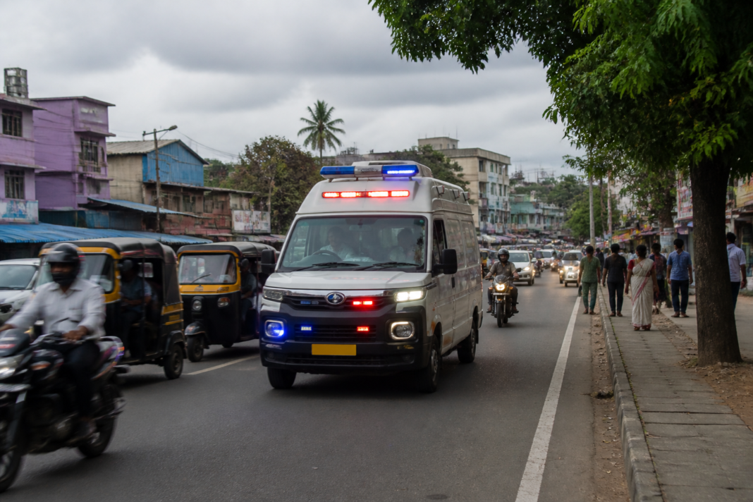 Kerala 108 ambulance service vehicle responding to an emergency on an urban road