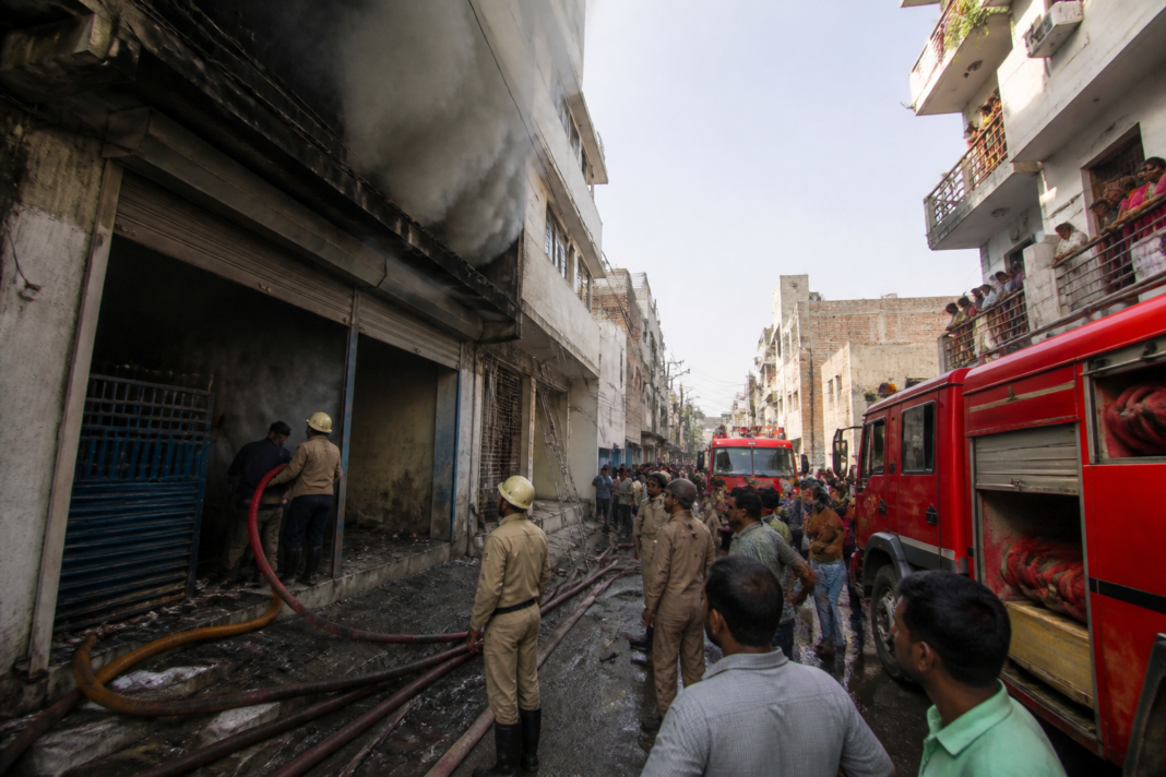 Delhi warehouse fire response with fire tenders outside a dense residential neighbourhood