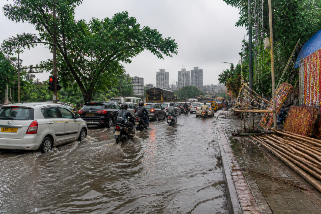 Thane rain causing waterlogging and traffic congestion near a busy city junction