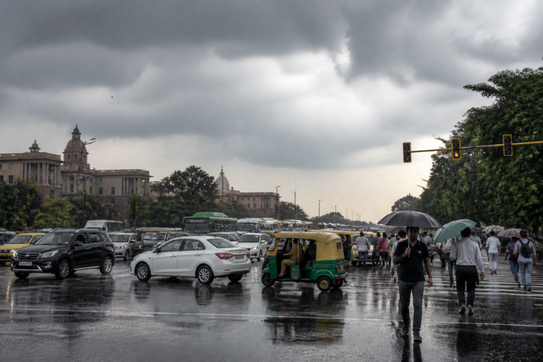 Delhi weather with dark clouds and light rain over a busy NCR road