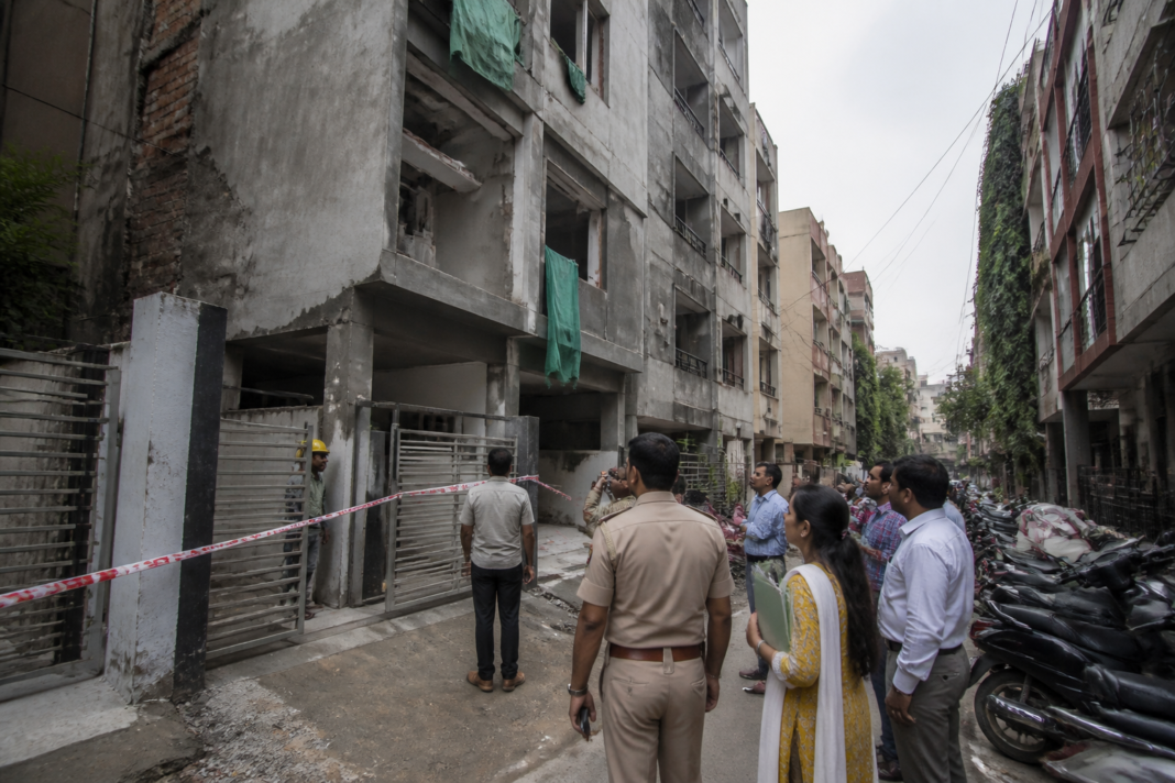 Delhi PG safety survey showing a dense student housing building under municipal inspection