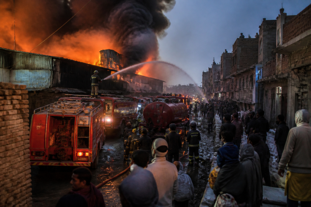 Dallupura fire crews tackling flames at an illegal wood godown in East Delhi