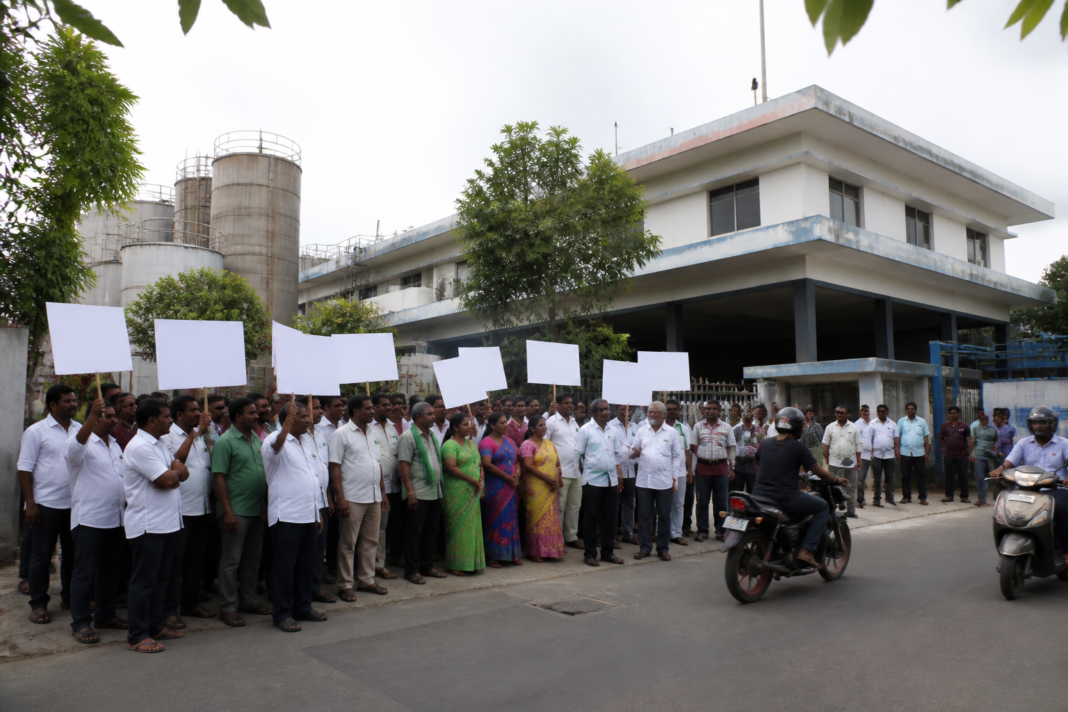 Vijaya Dairy milk price hike protest outside a dairy facility in Vijayawada
