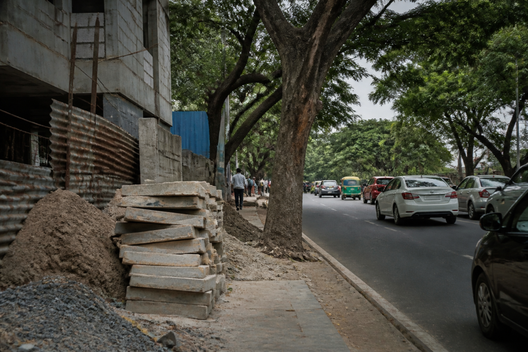 Bengaluru tree cutting dispute beside a blocked footpath in Indiranagar