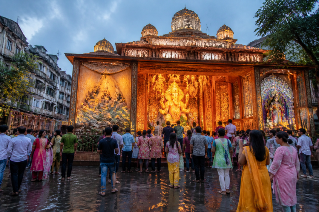 Kolkata Ganesh Puja pandal with cultural displays and visitors during the festive season