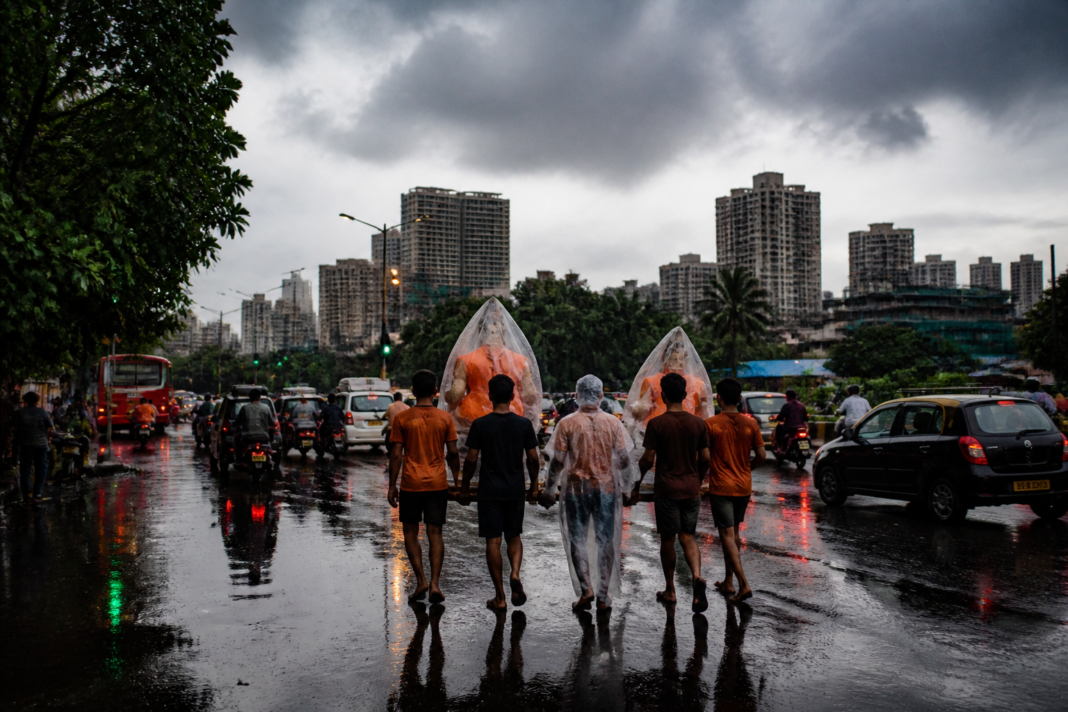 Mumbai weather alert as rain clouds gather over a city road during Ganesh Chaturthi