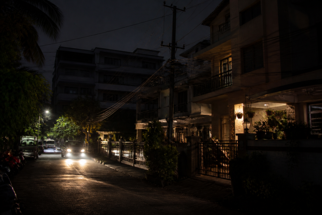 Kerala power shortage reflected by homes and streets during a nighttime electricity outage