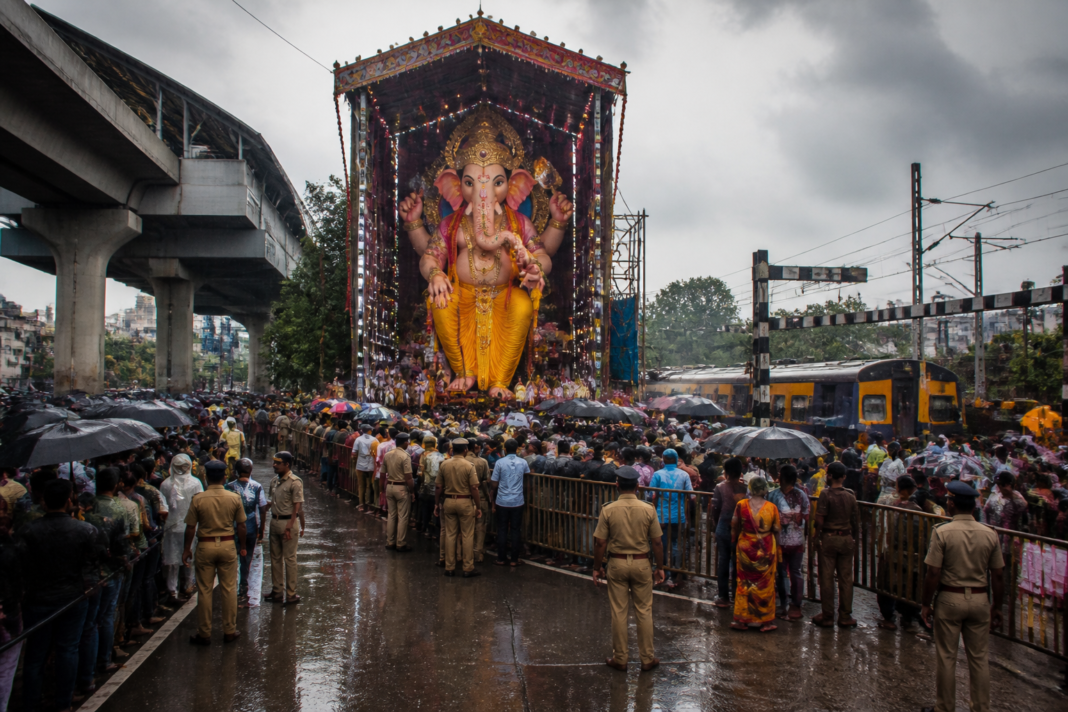 Khairatabad Ganesh idol and crowds gathering in Hyderabad during heavy rain