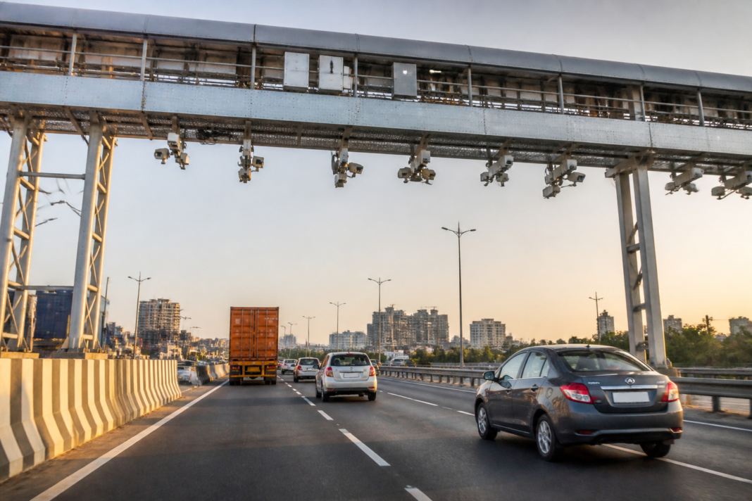 FASTag barrier-free tolling system on an Indian national highway with vehicles passing without stopping