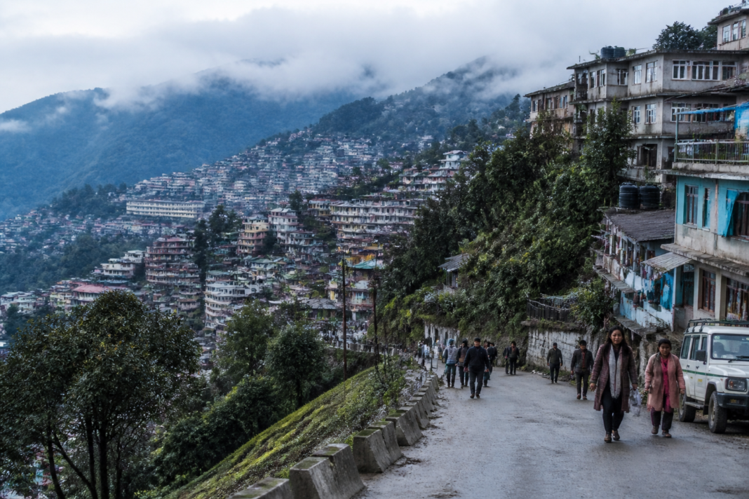 Darjeeling hills autonomy debate against a backdrop of hill-town homes and roads in Darjeeling