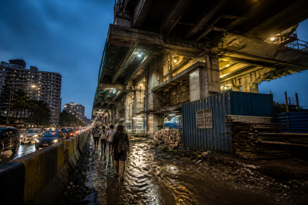Swami Samarth Nagar Metro station construction area with temporary lights and obstructed footpath