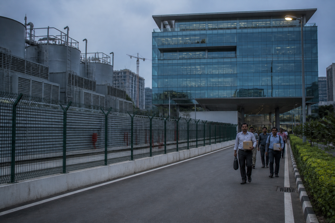 Oracle layoffs and AI infrastructure spending represented by a modern data centre campus