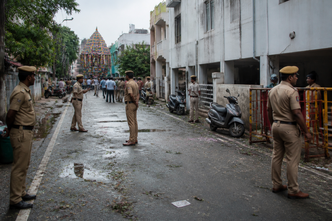 Police manage a Chennai street during a Vinayagar procession after an MTC driver’s death.