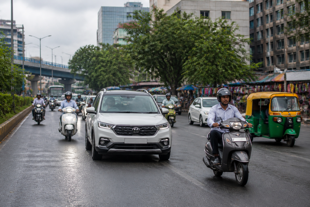 India auto sales reflected in cars, scooters and three-wheelers on a busy urban road