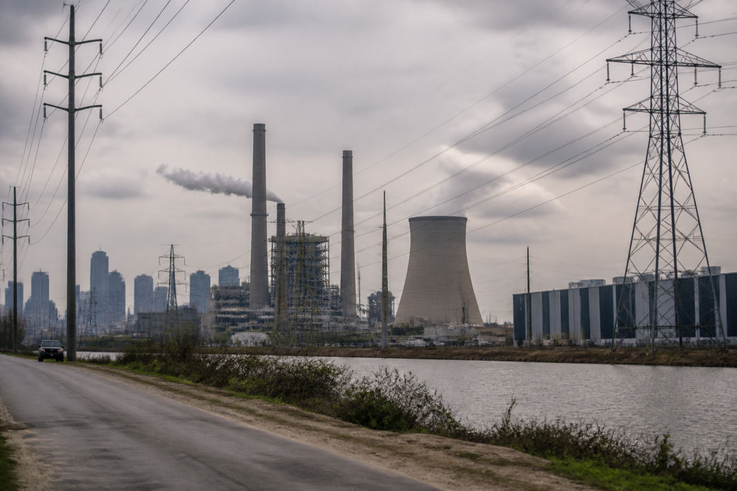 US power plant emissions policy shown by a coal and gas power station against an urban skyline