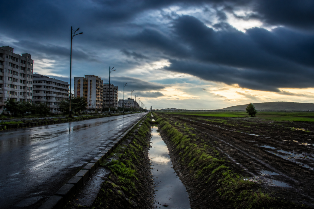Maharashtra monsoon deficit reflected in dark rain clouds over a city landscape