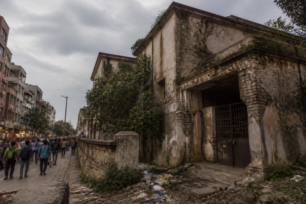 Delhi vacant MCD properties with a neglected civic building behind overgrown vegetation