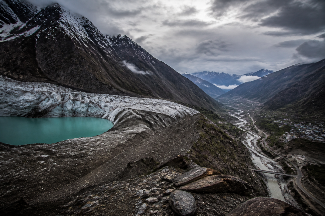 Himalayan glacier loss above a valley with an unstable glacial lake and downstream settlements