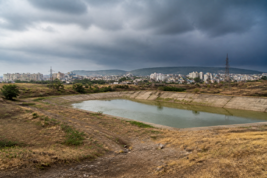 Maharashtra rainfall deficit as dark monsoon clouds gather over a dry urban landscape