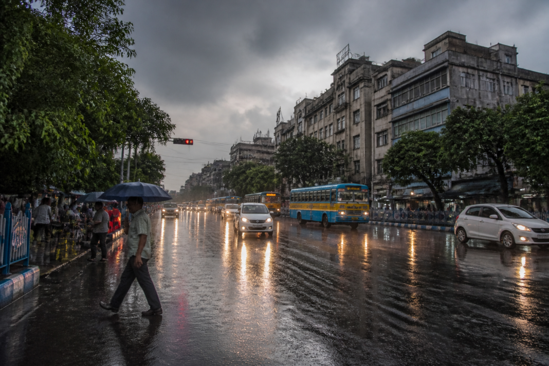 Kolkata rain forecast showing wet city streets under dark monsoon clouds