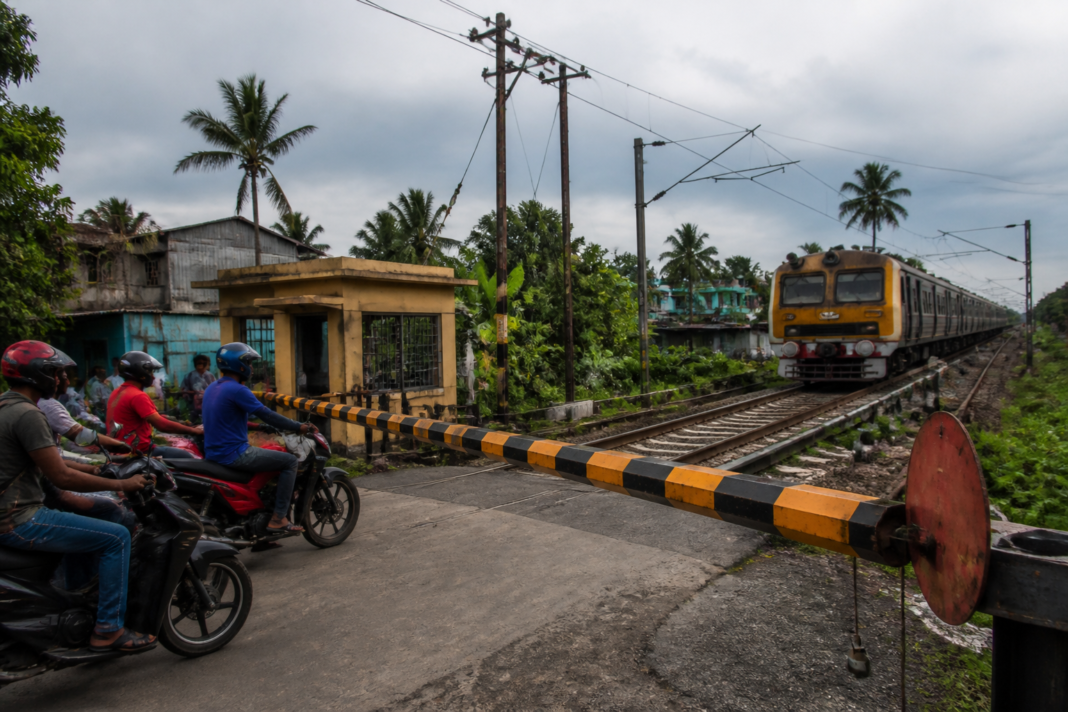 Hooghly railway gate near a level crossing with a local train approaching