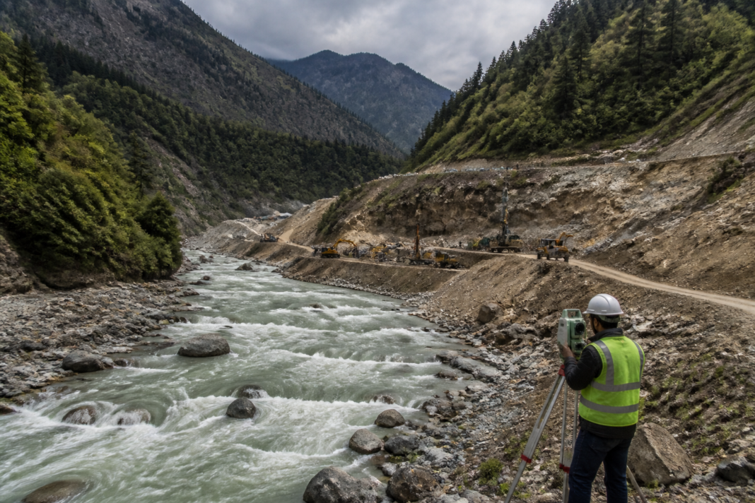 Kishau Dam project site in the Himalayan river basin with forested mountains and a proposed reservoir landscape