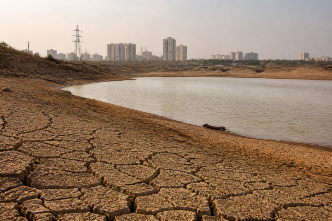 Karnataka drought conditions affecting a dry reservoir and surrounding urban water infrastructure