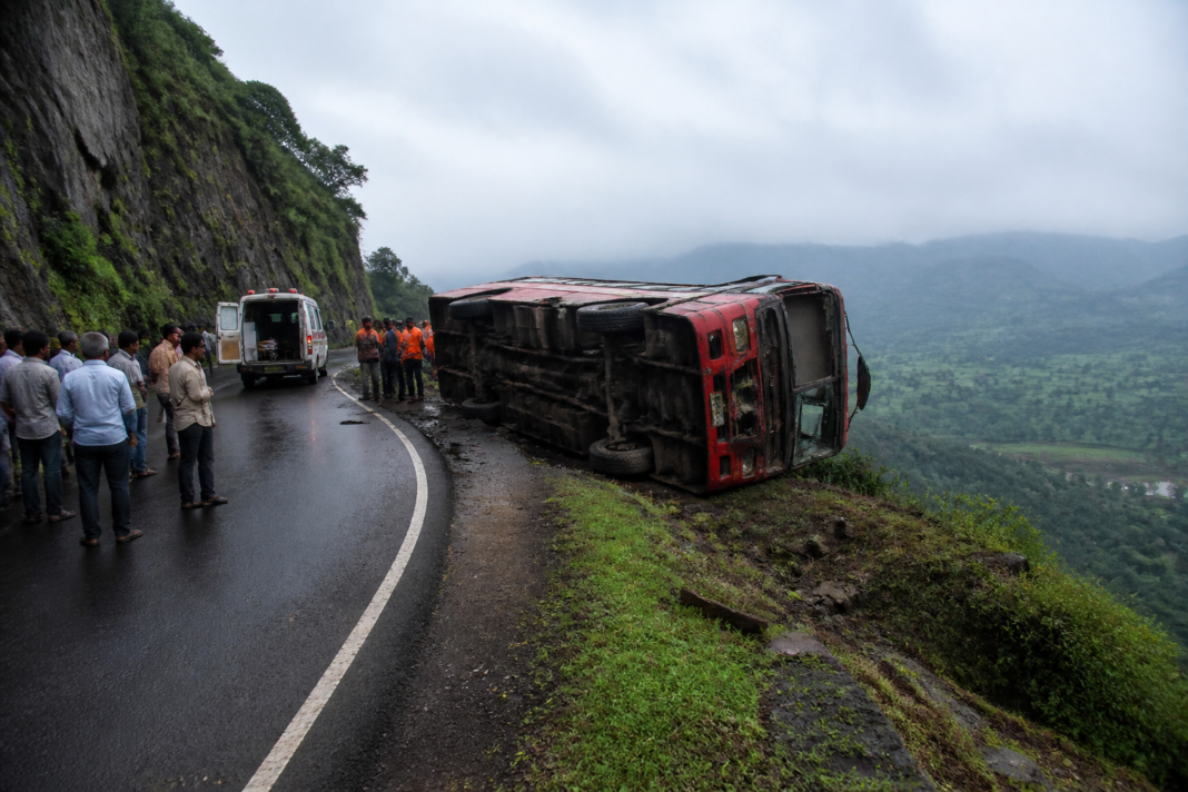Supe Ghat bus accident site near Baramati with a damaged school transport bus by a ghat road
