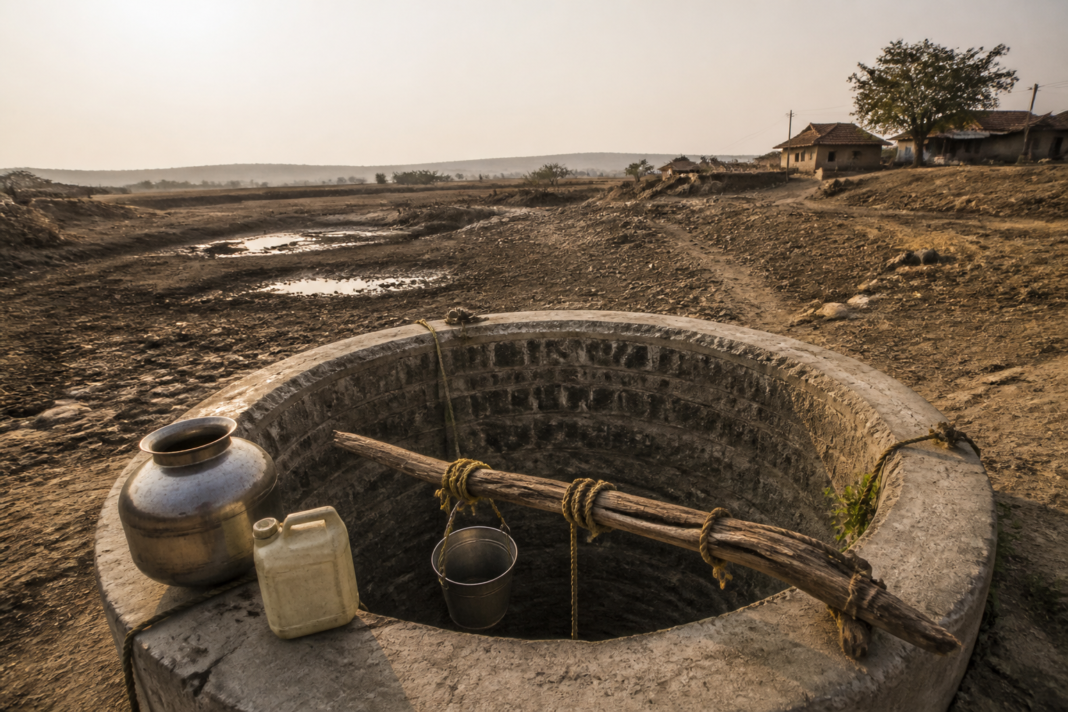 Maharashtra drought warning and a rural drinking-water source surrounded by dry ground