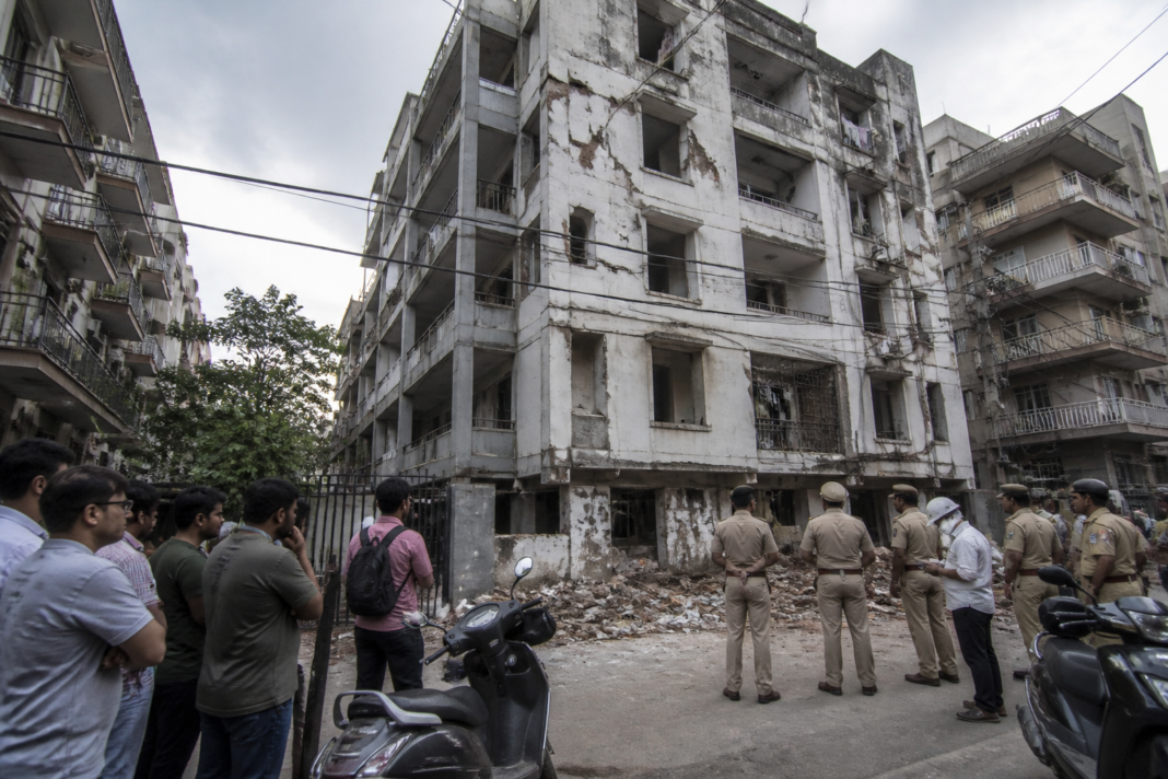 Delhi hostel safety concerns outside a dense student housing area after a building collapse