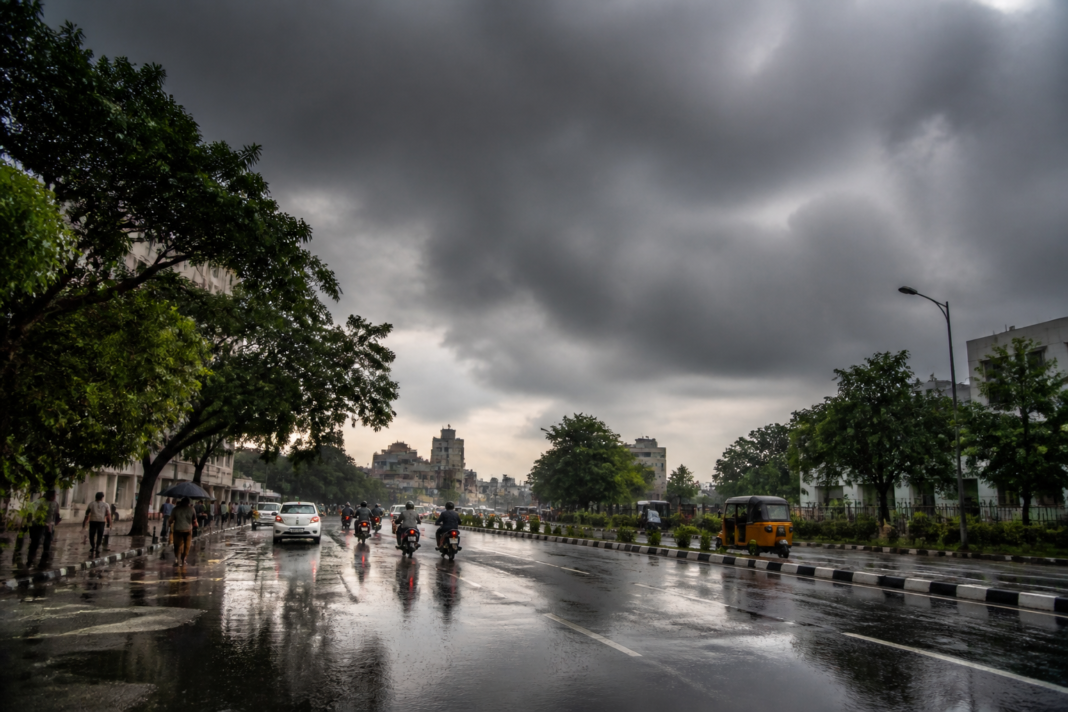 Chennai rain forecast showing dark monsoon clouds over the city's urban skyline