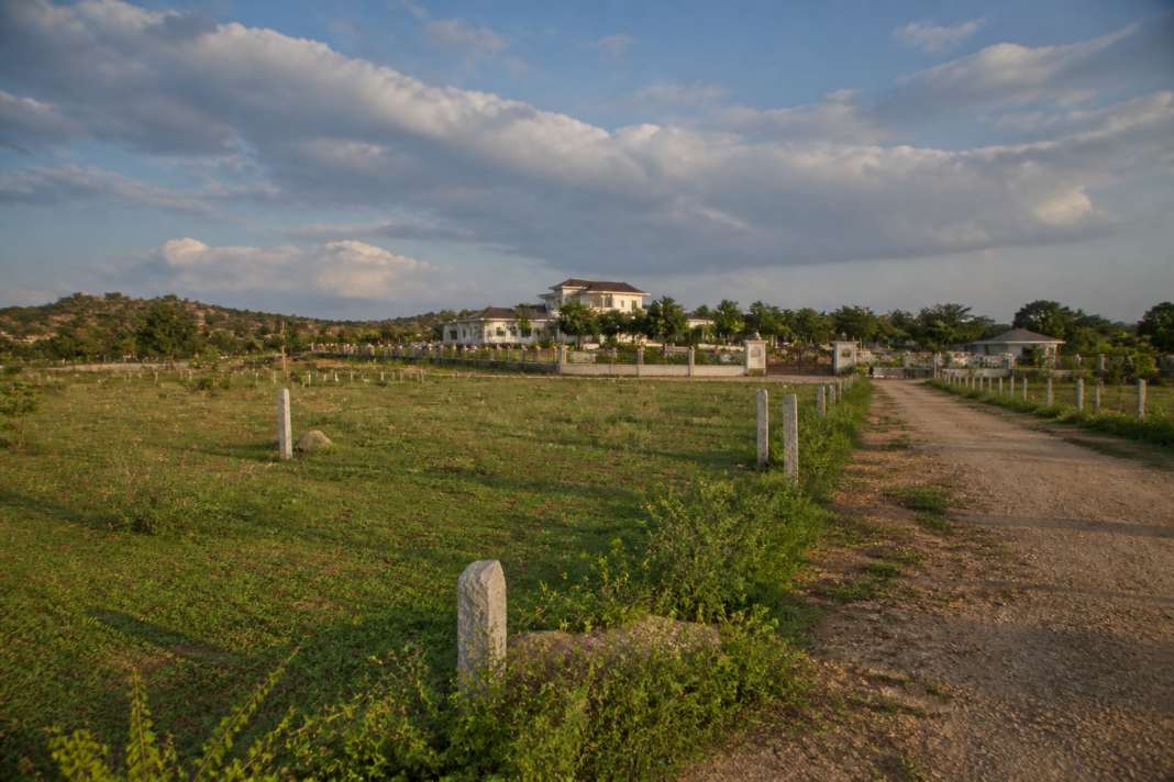 Telangana land probe near a farmhouse in Erravelli, with agricultural land and survey markers