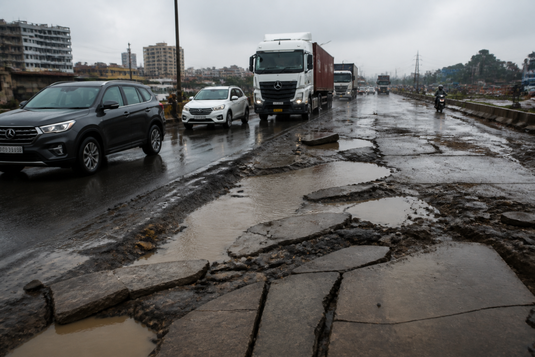 Mumbai-Ahmedabad Highway potholes and cracked concrete near Vasai-Virar