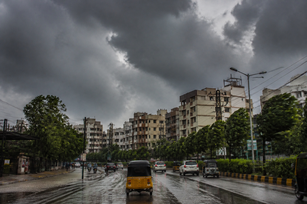 Telangana rain forecast showing dark monsoon clouds over Hyderabad streets