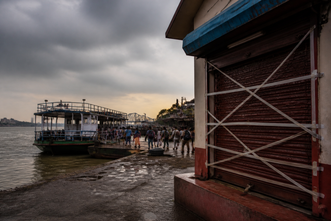 Kolkata ferry service at a Hooghly River ghat near a sealed ticket counter