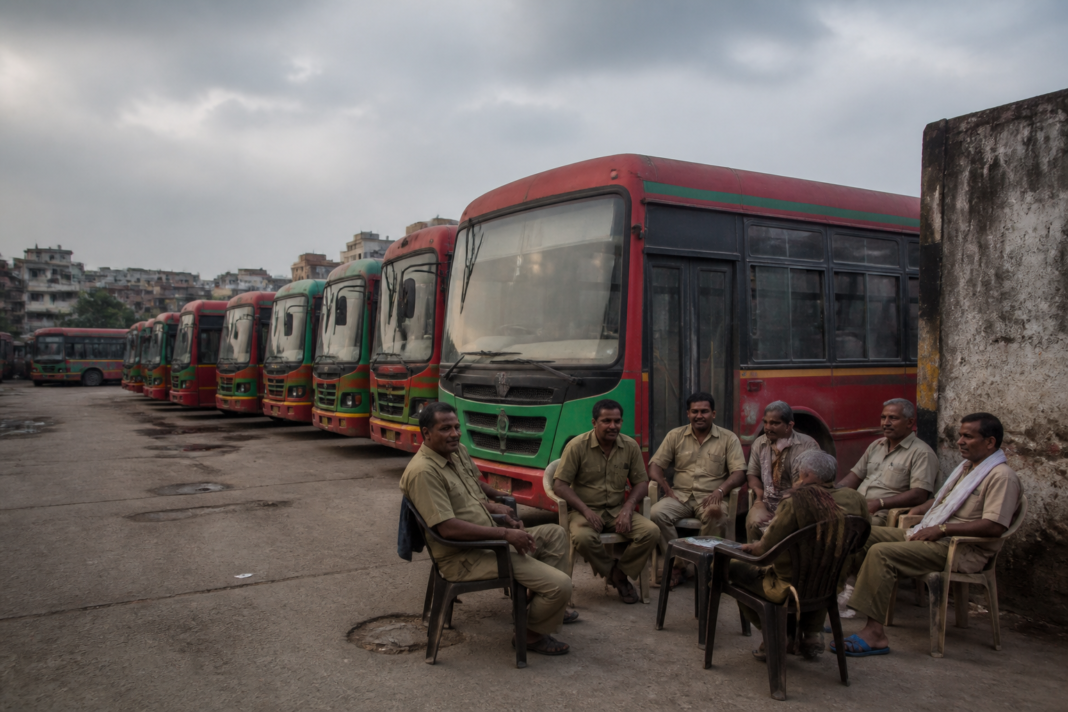 Delhi bus strike leaves DTC buses parked at a depot as drivers wait outside