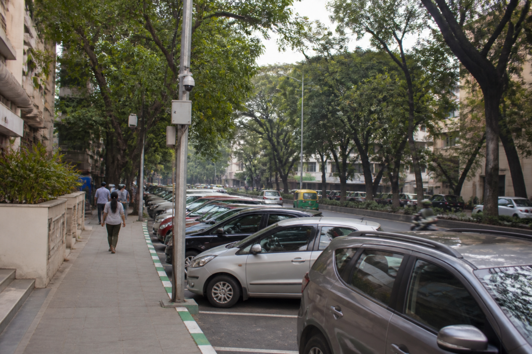 AI smart parking Bengaluru pilot planned on a busy Jayanagar road with marked parking spaces.