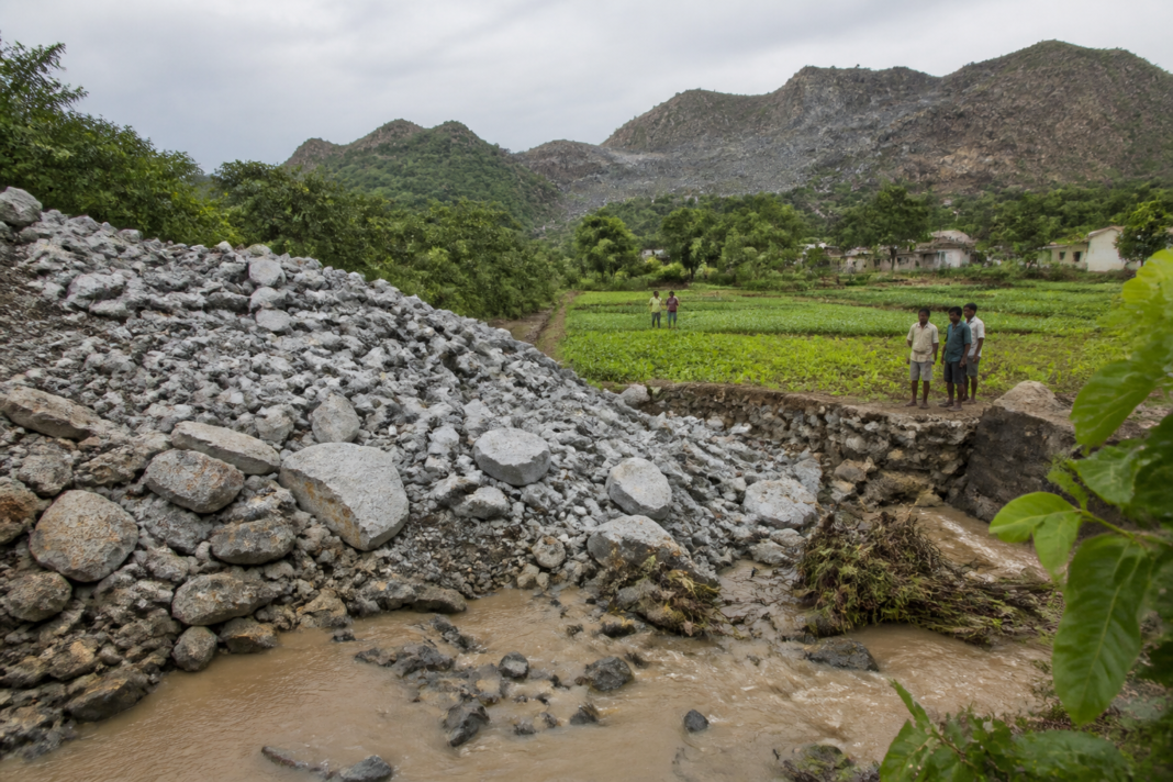 Anakapalli granite quarrying debris near a rural stream and tribal farmland in Andhra Pradesh
