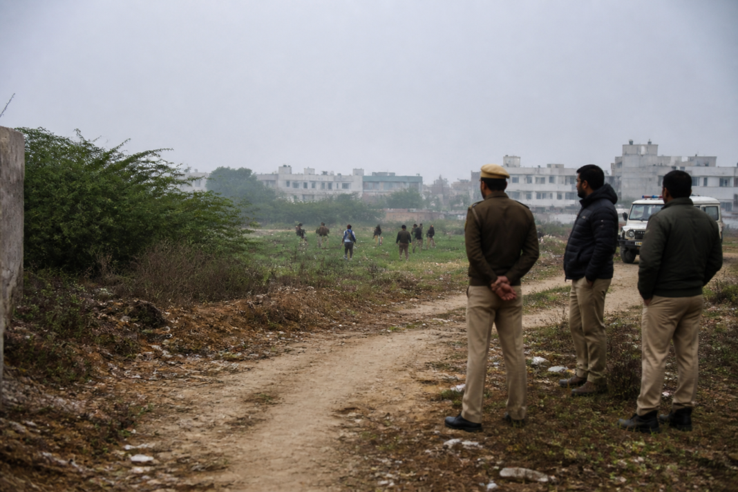 Delhi Police investigation near an open field in Outer North Delhi
