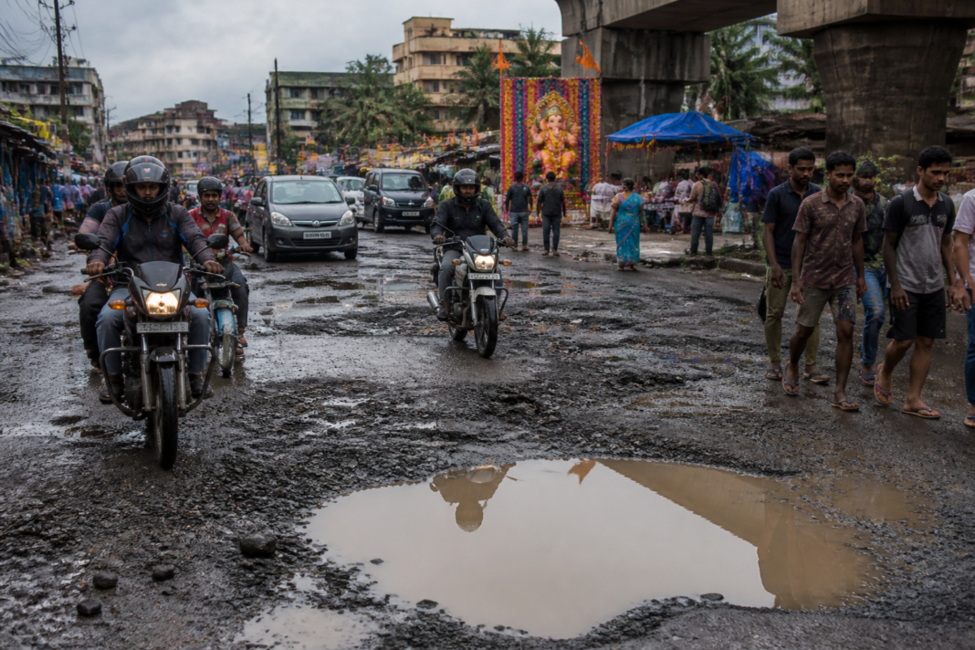 Vasai Virar potholes disrupting traffic on a city road during Ganeshotsav