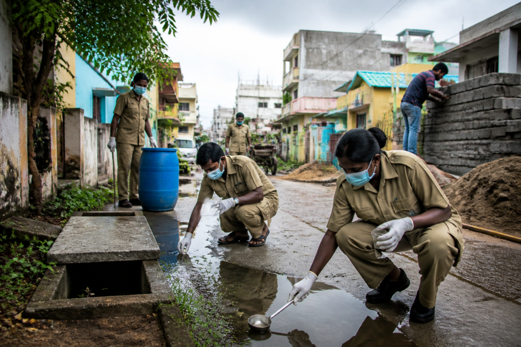 Tamil Nadu dengue cases prompt mosquito-control workers to inspect stagnant water near homes.