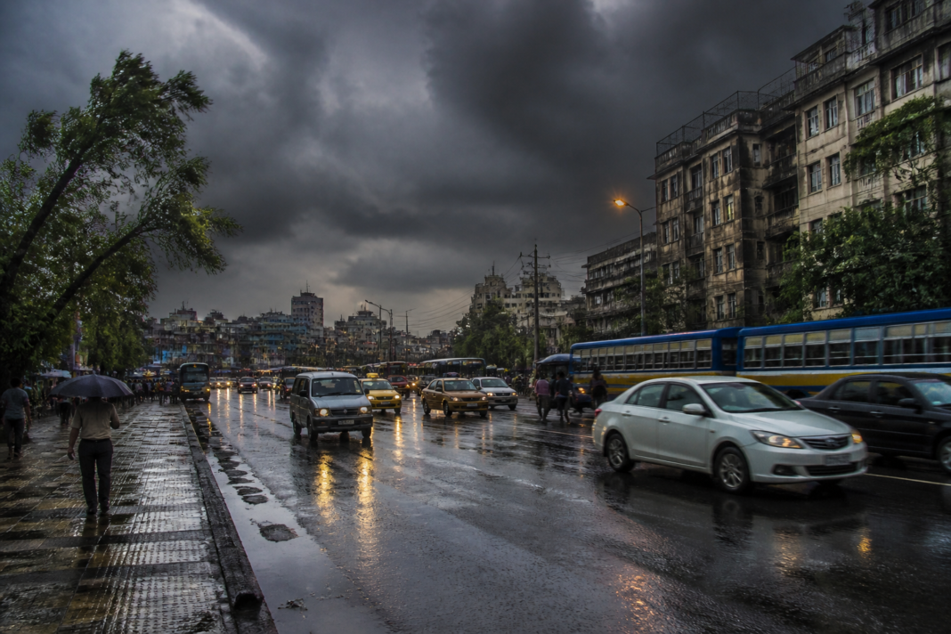 West Bengal rain forecast showing storm clouds over a Kolkata street