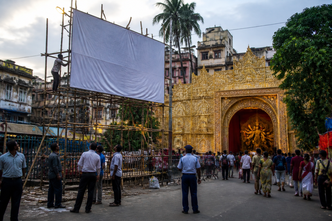 Kolkata puja hoardings near a Durga Puja pandal under new KMC rules